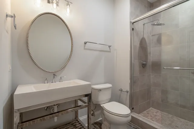 a bathroom with a sink toilet and a mirror