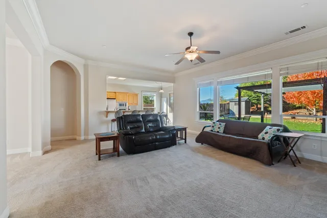 a living room with furniture and a chandelier