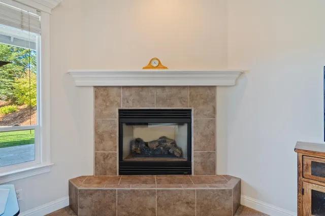 a living room with a fireplace and a window