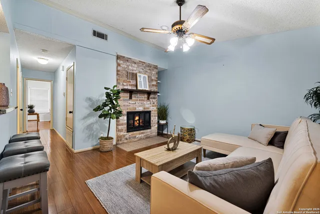 a living room with furniture and a fireplace