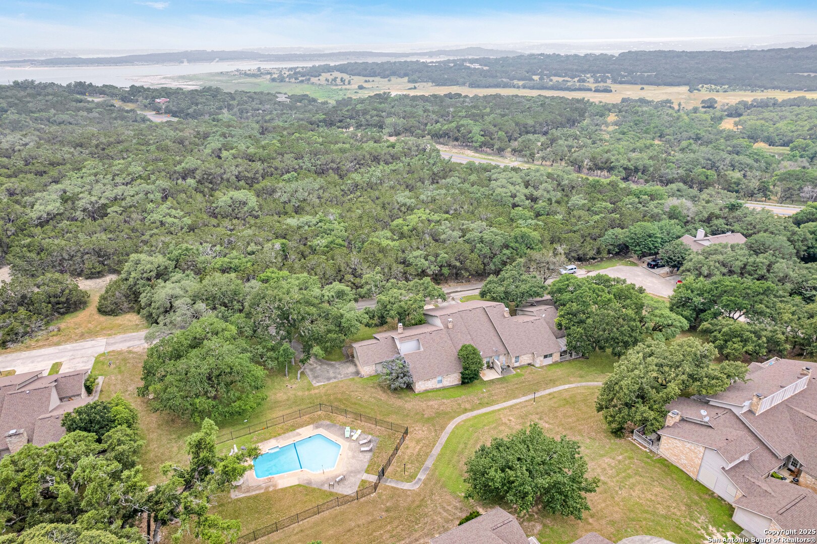 60 Oak Villa Road, Unit F3 Canyon Lake, TX 78133 - Photo 19 of 22 a view of a city with lush green forest