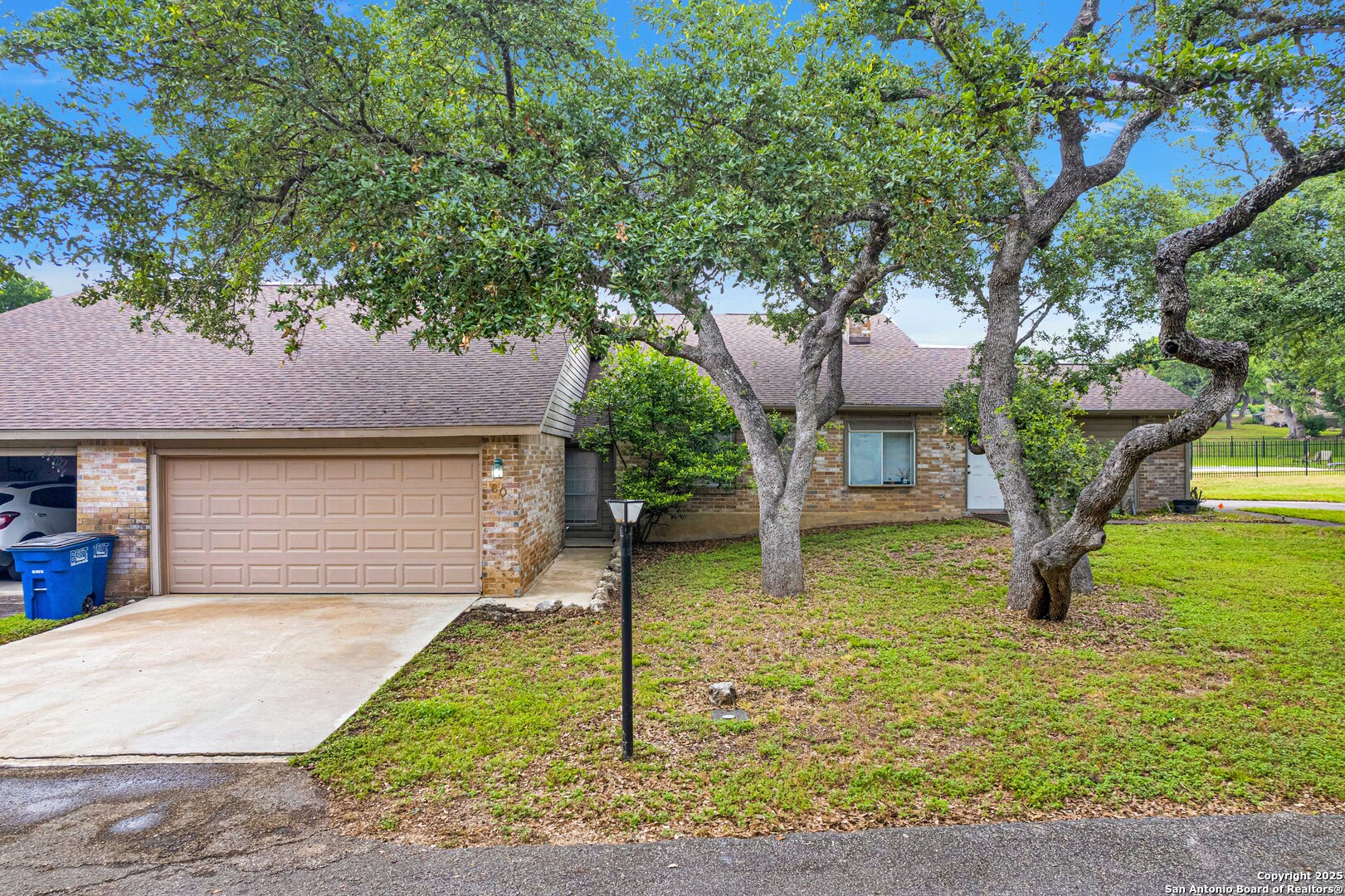 60 Oak Villa Road, Unit F3 Canyon Lake, TX 78133 - Photo 2 of 22 a front view of a house with garden