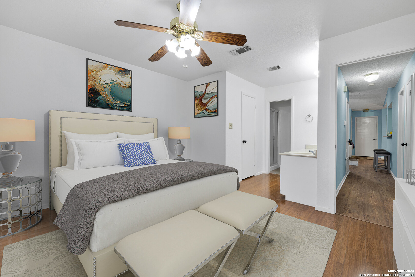 60 Oak Villa Road, Unit F3 Canyon Lake, TX 78133 - Photo 10 of 22 a bedroom with a bed and a chandelier