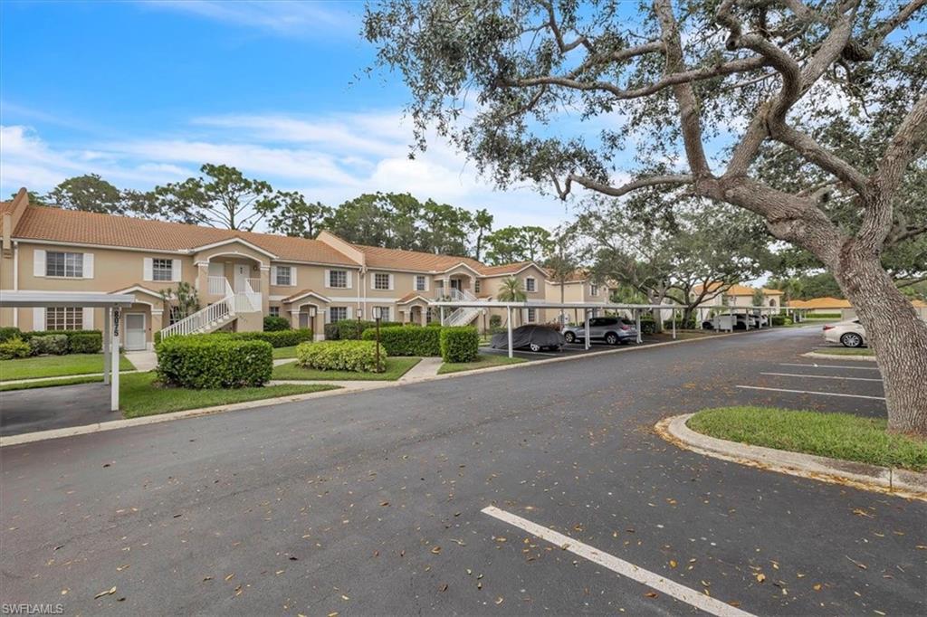 8075 Tiger Cove, Unit 1706 Naples, FL 34113 - Photo 47 of 50 View of asphalt street featuring a residential view, curbs, and stairway