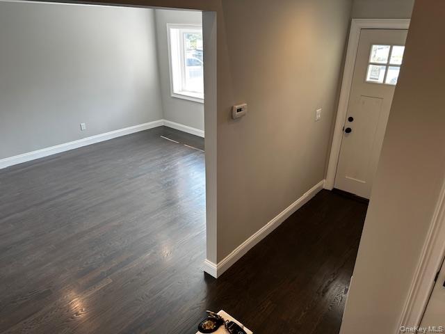 558 Oxford Road Cedarhurst, NY 11516 - Photo 11 of 22 Entryway with baseboards and dark wood-style floors