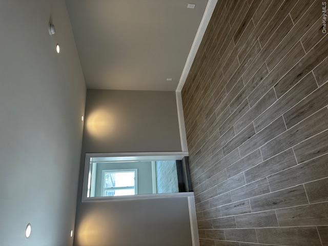 558 Oxford Road Cedarhurst, NY 11516 - Photo 16 of 22 an empty room with wooden floor and windows