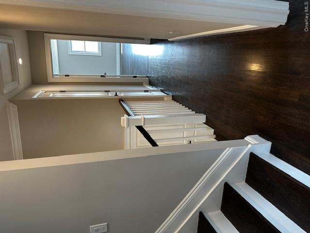 558 Oxford Road Cedarhurst, NY 11516 - Photo 10 of 22 a view of a hallway with wooden floor and staircase
