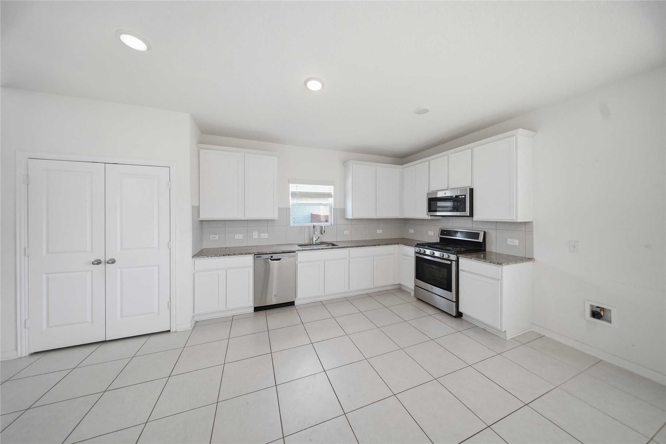 513 Warlander Way Georgetown, TX 78626 - Photo 11 of 35 a large white kitchen with cabinets