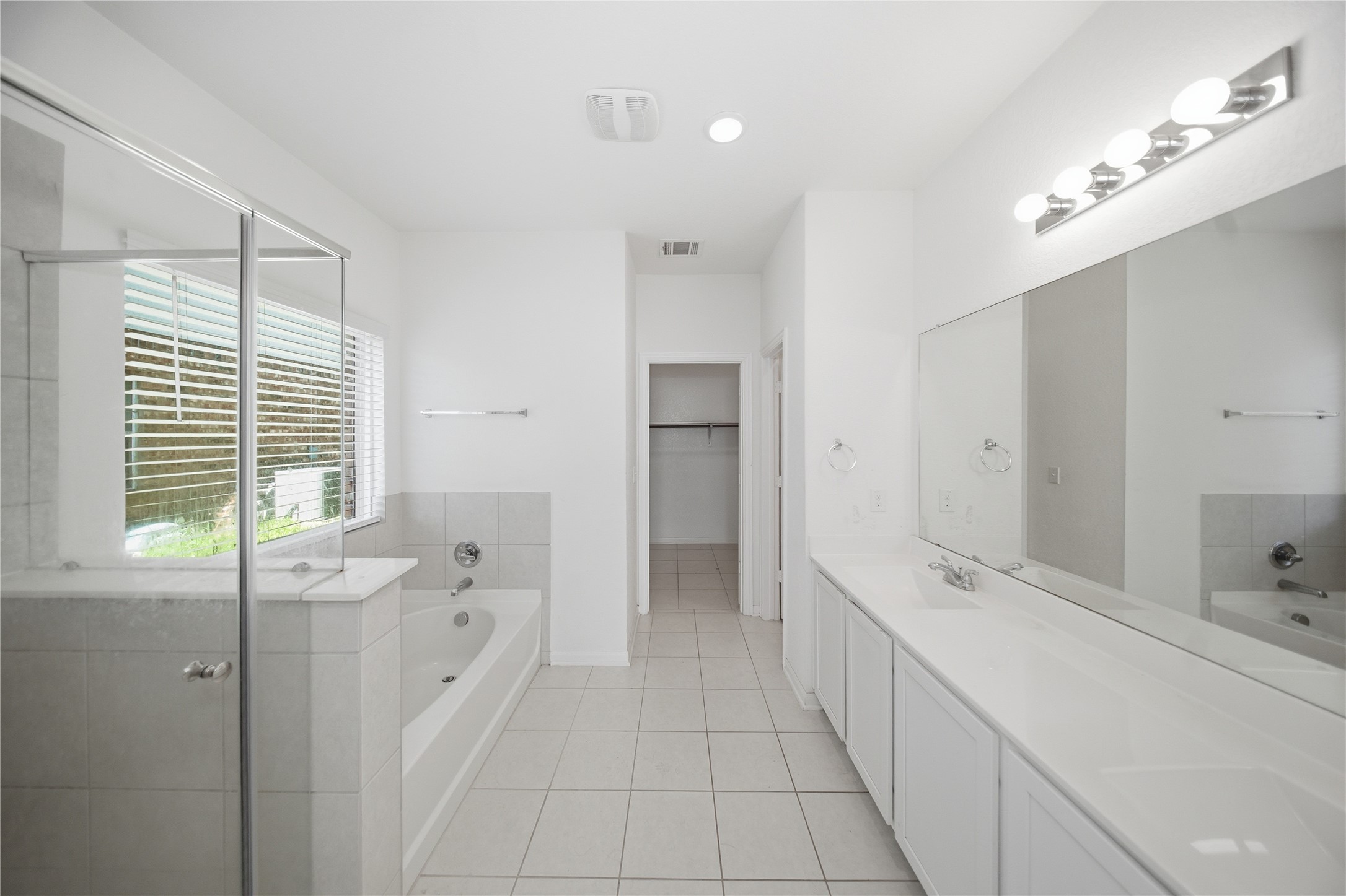 513 Warlander Way Georgetown, TX 78626 - Photo 15 of 35 a spacious bathroom with a double vanity sink a mirror and a bathtub