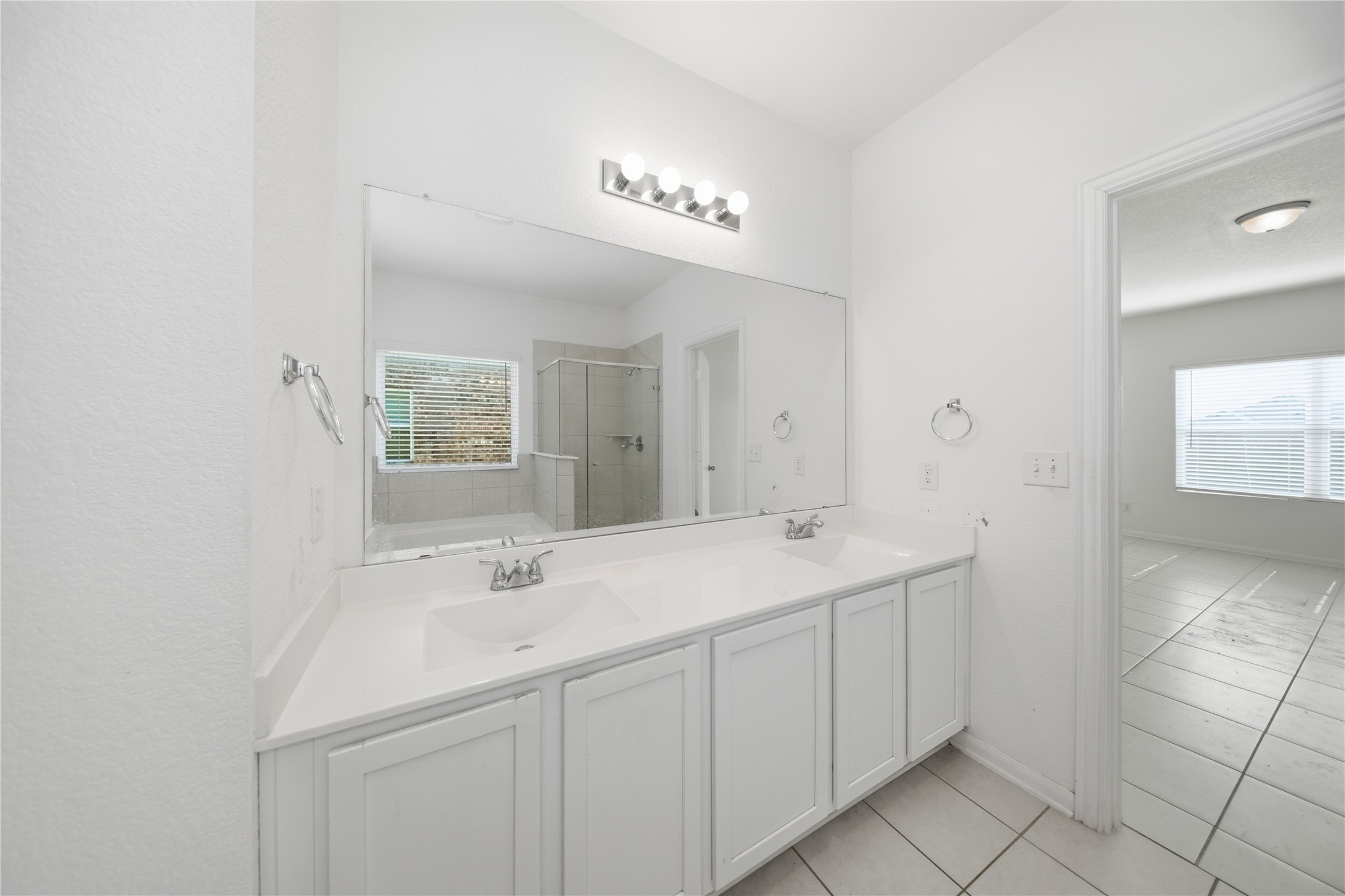 513 Warlander Way Georgetown, TX 78626 - Photo 27 of 35 a bathroom with a sink a large mirror and a shower