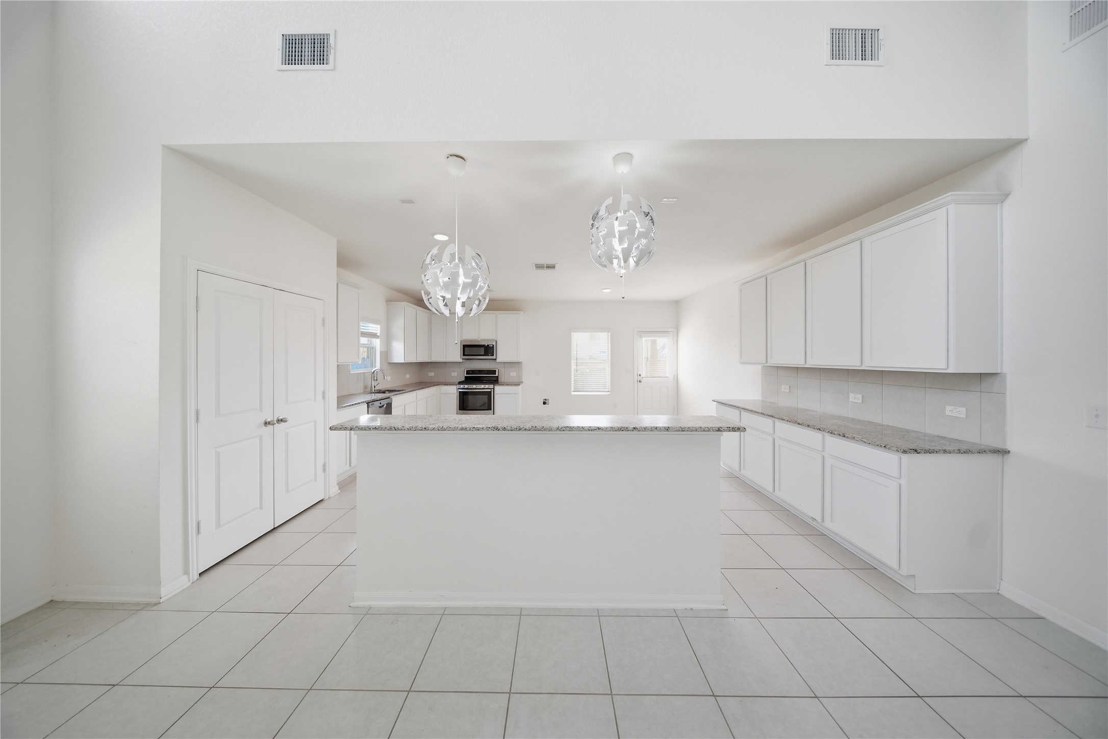 513 Warlander Way Georgetown, TX 78626 - Photo 9 of 35 a large white kitchen with cabinets and a fireplace