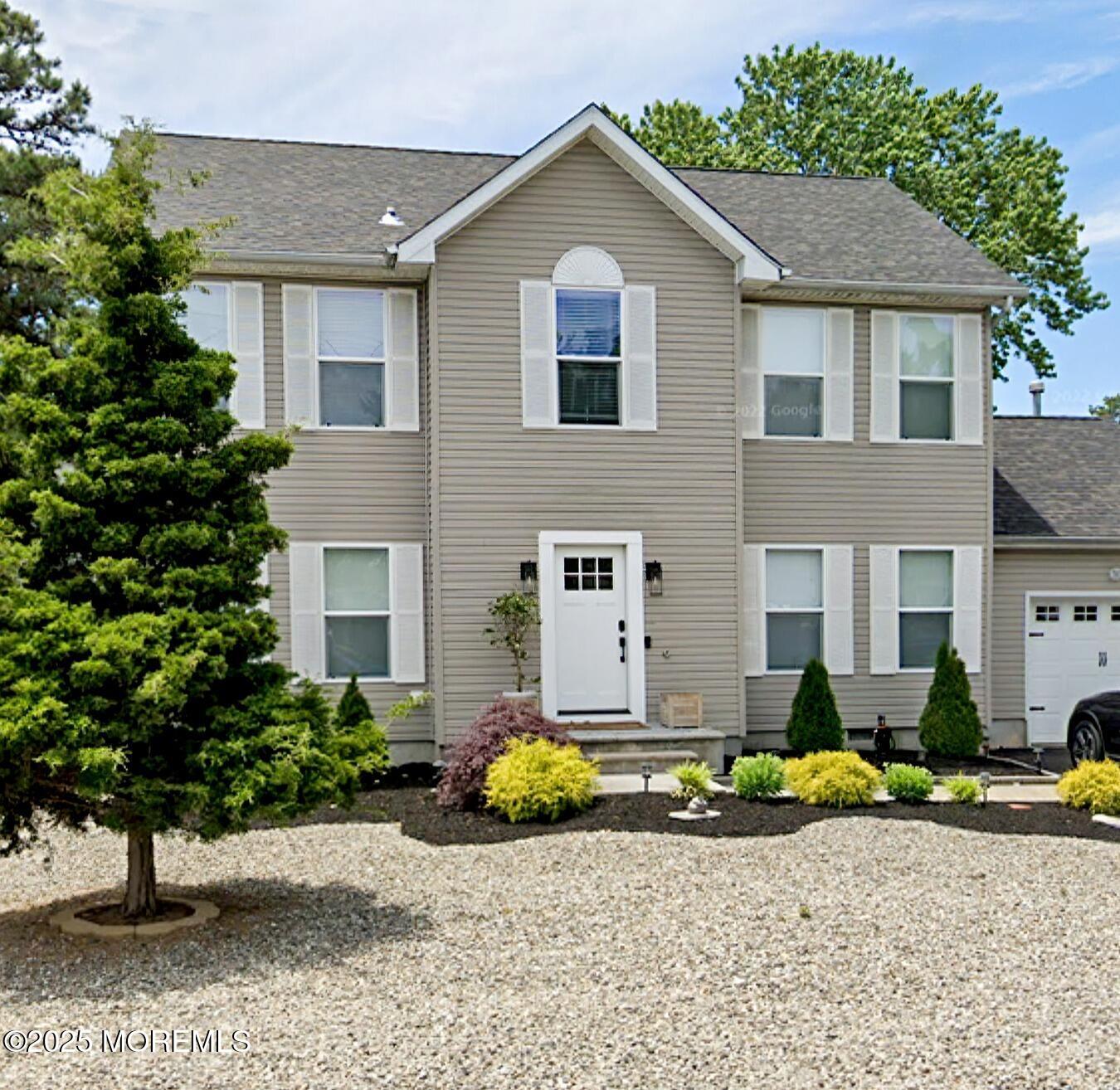 194 Club House Road Brick, NJ 08723 - Photo 1 of 45 a front view of a house with a yard and sitting area