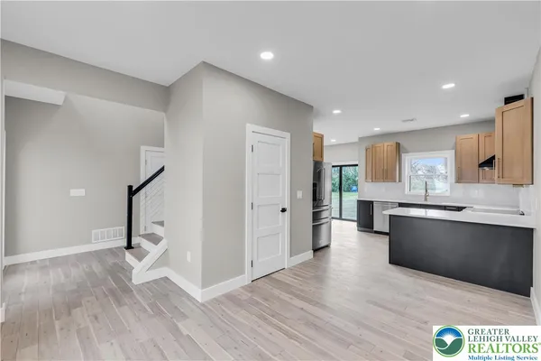a kitchen with a sink a counter top space and cabinets