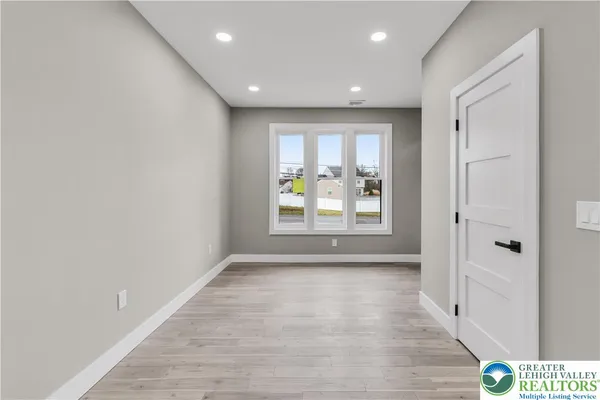 a large kitchen with kitchen island a large counter top space stainless steel appliances and cabinets