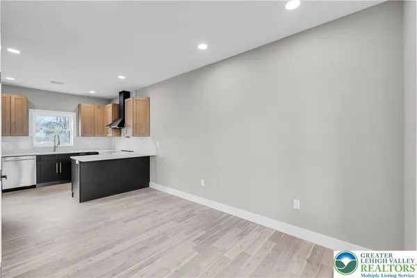a kitchen with stainless steel appliances a sink stove and cabinets