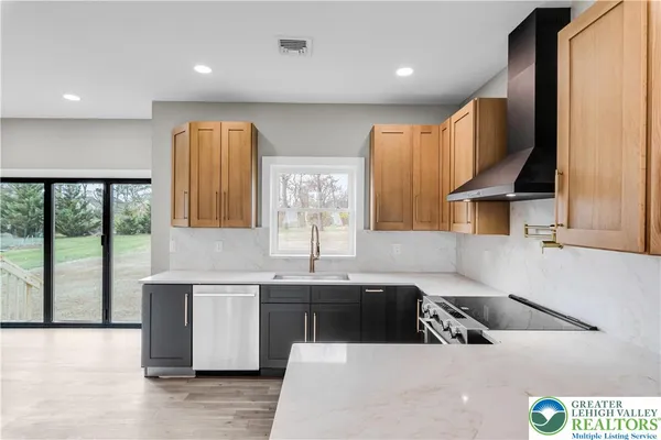 a kitchen with stainless steel appliances a refrigerator and wooden floor