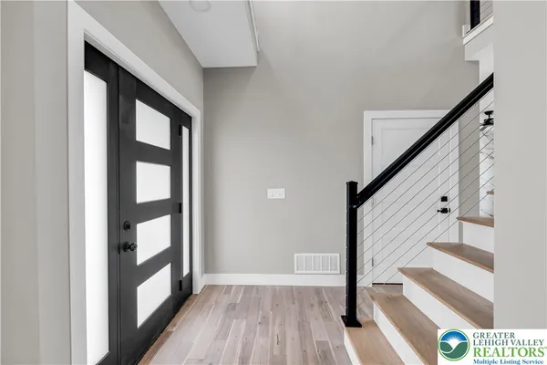 a view of an entryway with wooden floor