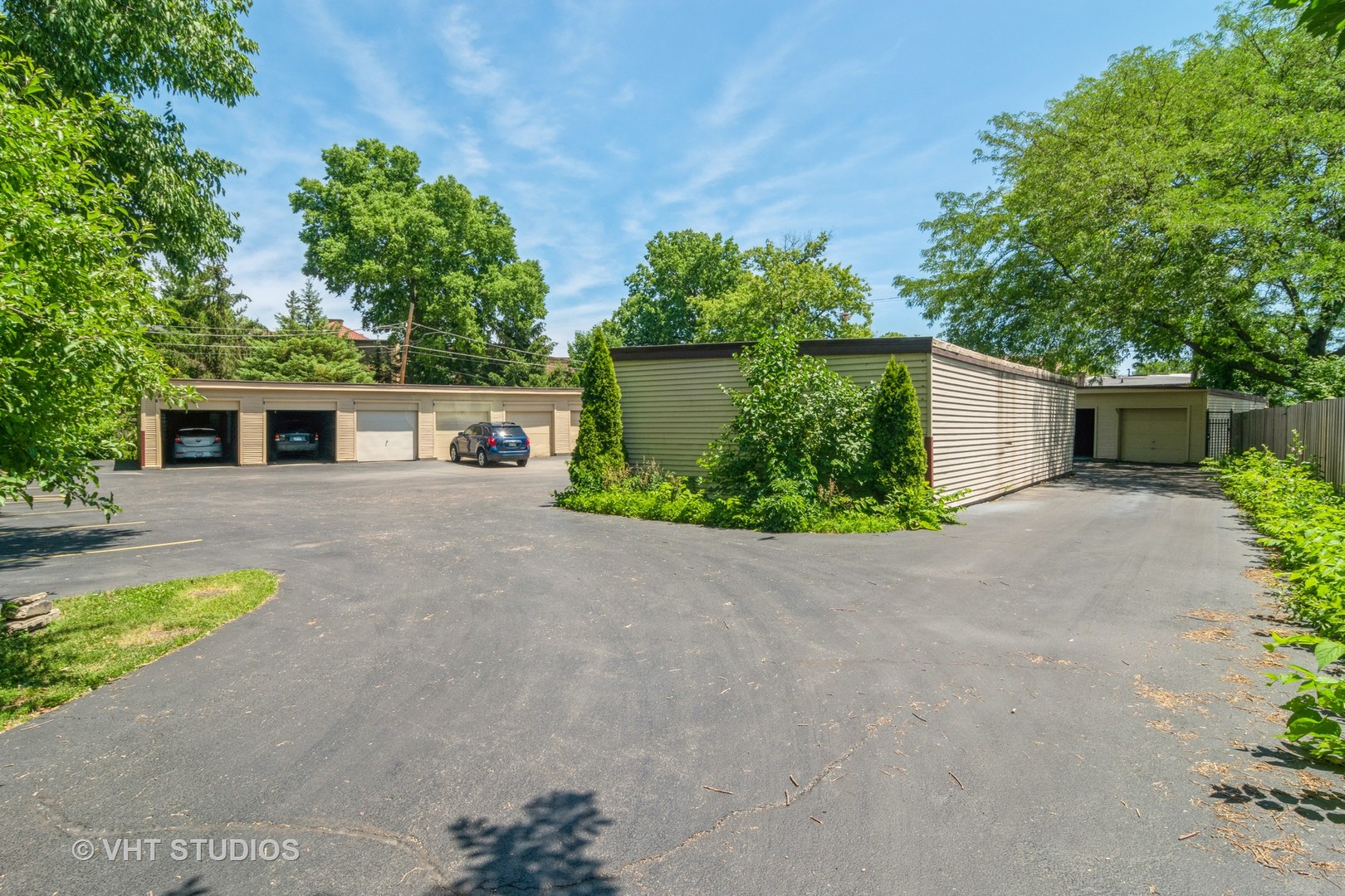65 Longcommon Road, Unit G Riverside, IL 60546 - Photo 11 of 19 front view of a house with potted plants and a large tree