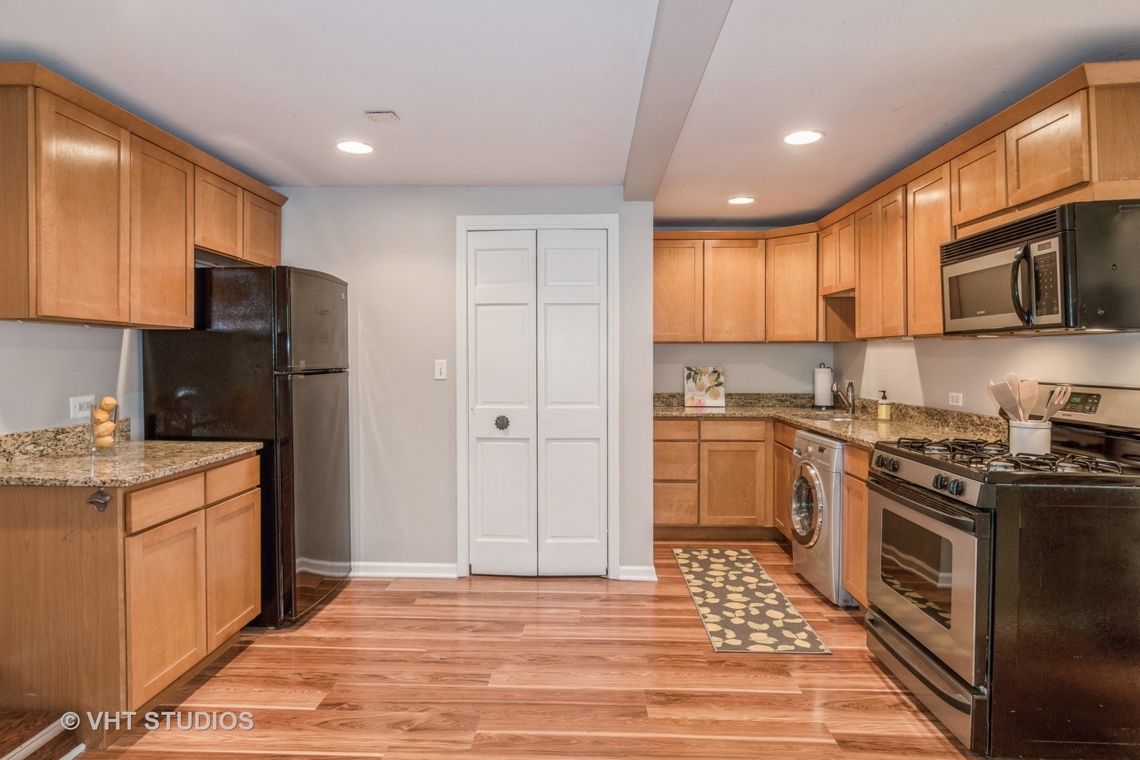 65 Longcommon Road, Unit G Riverside, IL 60546 - Photo 5 of 19 a kitchen with stainless steel appliances granite countertop a stove a sink and a refrigerator