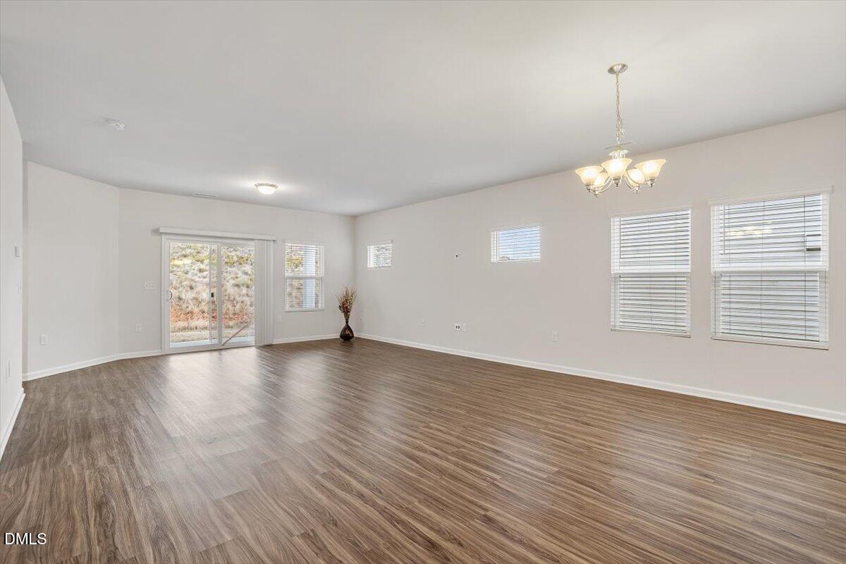 46 Coffee Tree Circle Clayton, NC 27527 - Photo 13 of 36 an empty room with wooden floor and windows