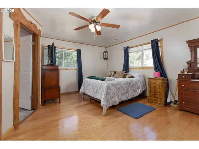 a bedroom with a bed and dresser with mirror
