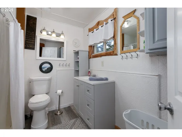a bathroom with a toilet a sink and mirror