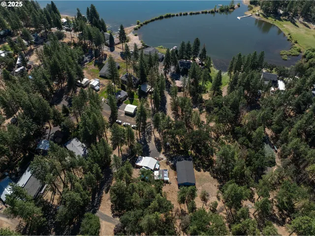 an aerial view of a house with yard and outdoor seating