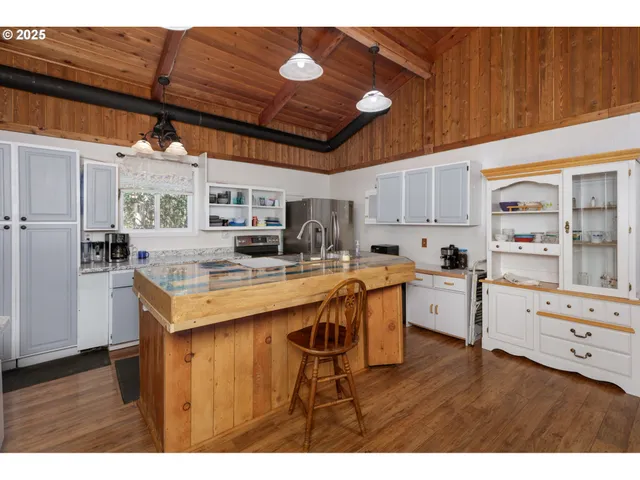 a kitchen with stainless steel appliances granite countertop a sink a stove and a refrigerator
