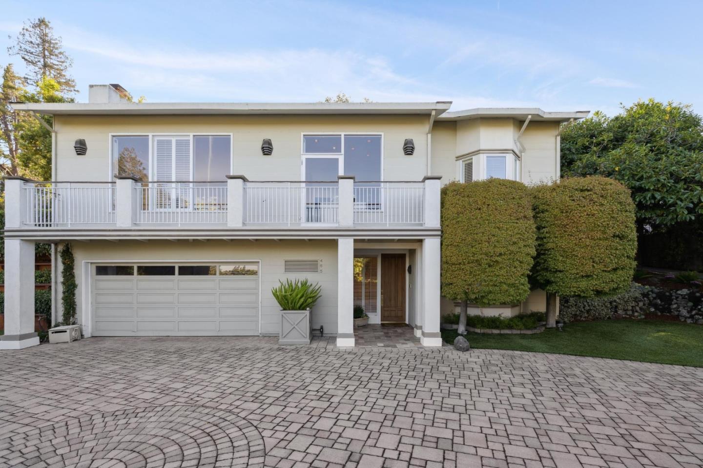 a front view of a house with garden
