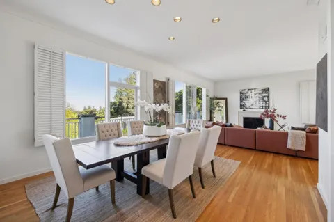 a dining room with furniture and wooden floor