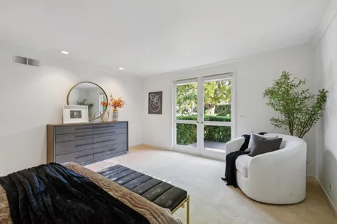 a bedroom with furniture and a window