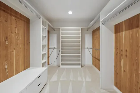 a view of walk in closet with empty racks