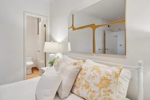 a bedroom with a bed and a lamp