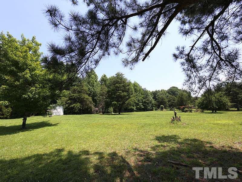 7408 Wiley Mangum Road Bahama, NC 27503 - Photo 12 of 13 a view of a field with a tree in the background