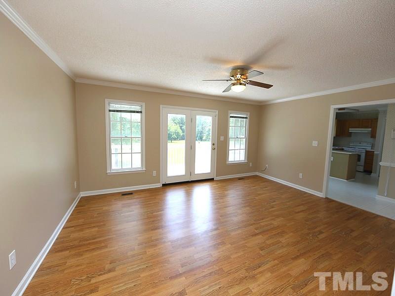 7408 Wiley Mangum Road Bahama, NC 27503 - Photo 3 of 13 an empty room with wooden floor and windows