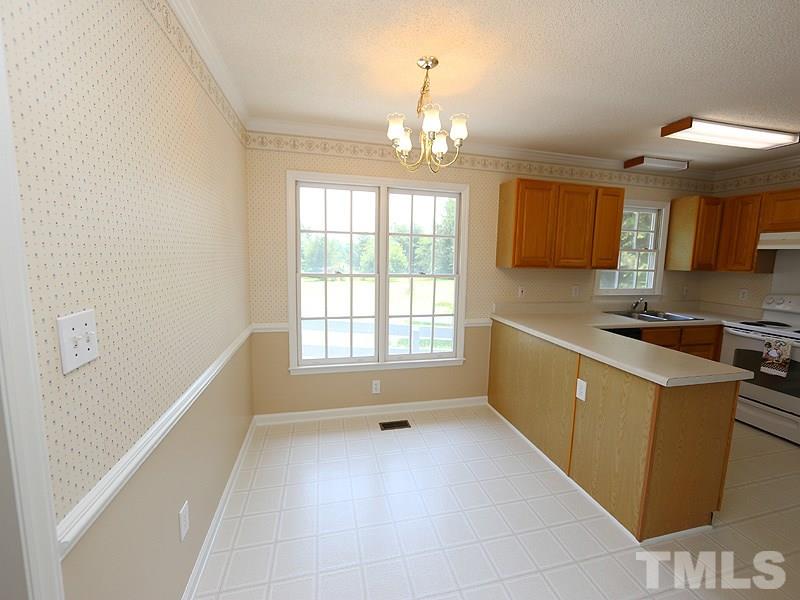 7408 Wiley Mangum Road Bahama, NC 27503 - Photo 6 of 13 a kitchen with a sink appliances and cabinets