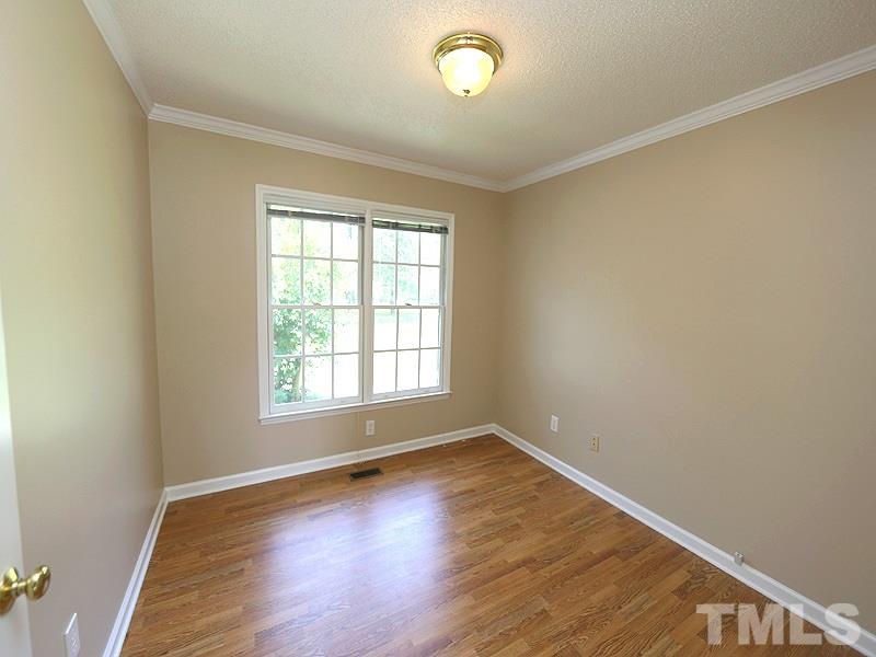 7408 Wiley Mangum Road Bahama, NC 27503 - Photo 7 of 13 an empty room with wooden floor and windows
