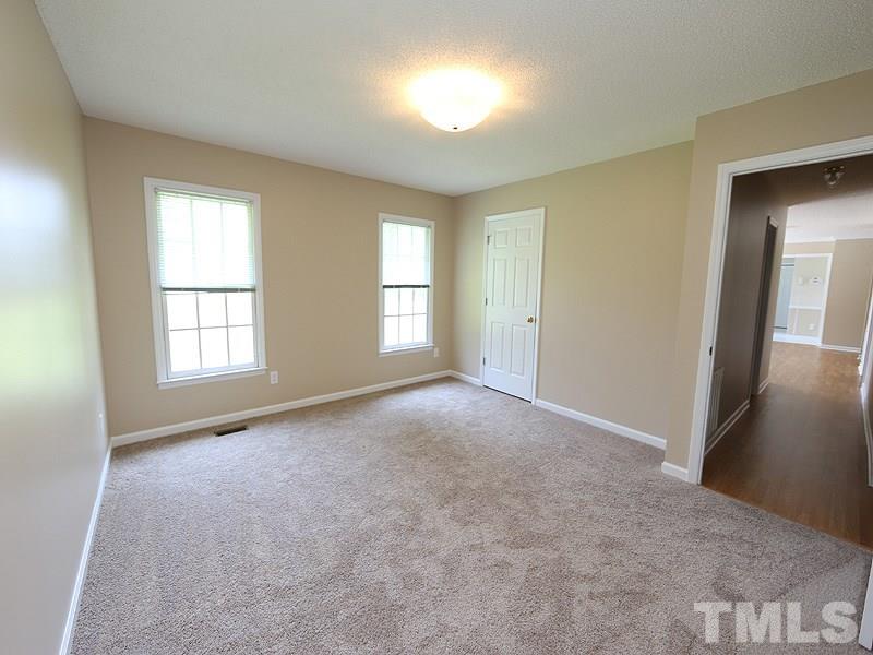 7408 Wiley Mangum Road Bahama, NC 27503 - Photo 8 of 13 an empty room with windows and closet