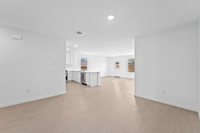 a view of a kitchen with a sink and a refrigerator