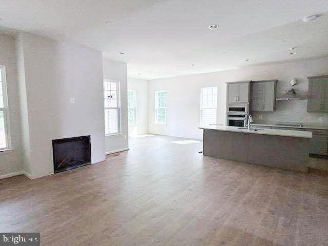 9285 Crestview Rdg Drive Bristow, VA 20136 - Photo 4 of 25 a living room with stainless steel appliances kitchen island a large counter top a sink and a refrigerator
