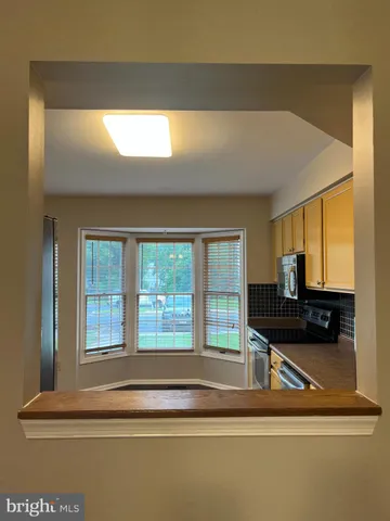 a view of staircase with wooden floor and window