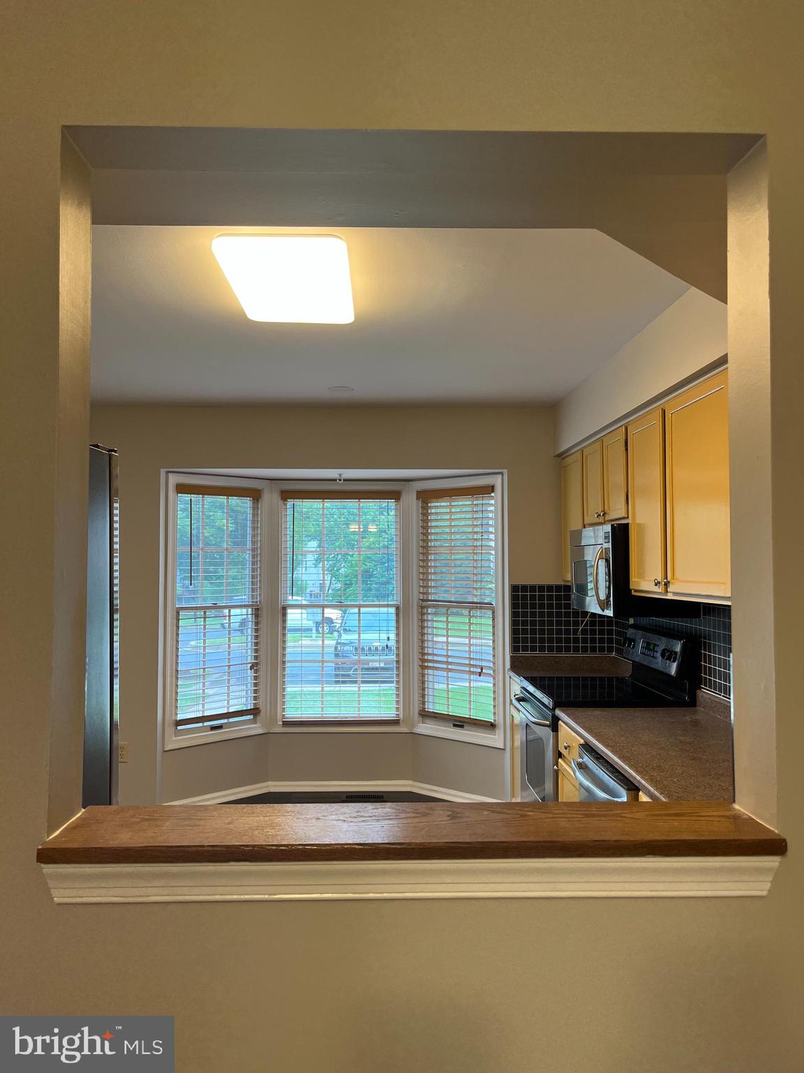 1049 Wingate Court, Unit I14 Bel Air, MD 21014 - Photo 16 of 61 a living room with a table chairs and a refrigerator