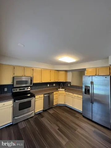 a kitchen with a stove and a microwave