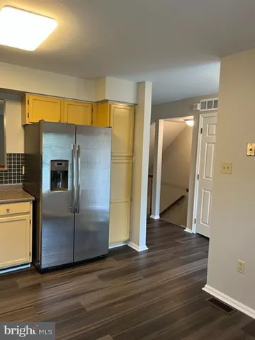 a view of staircase with railing and a window