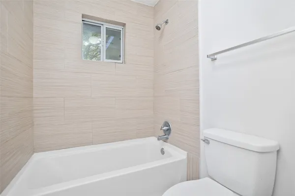 a bathroom with a toilet and a bathtub
