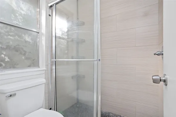 a bathroom with a glass shower door