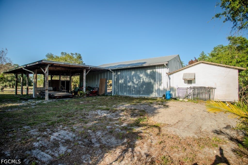 3880 Packinghouse Road Alva, FL 33920 - Photo 28 of 29 a view of a house with backyard and sitting area