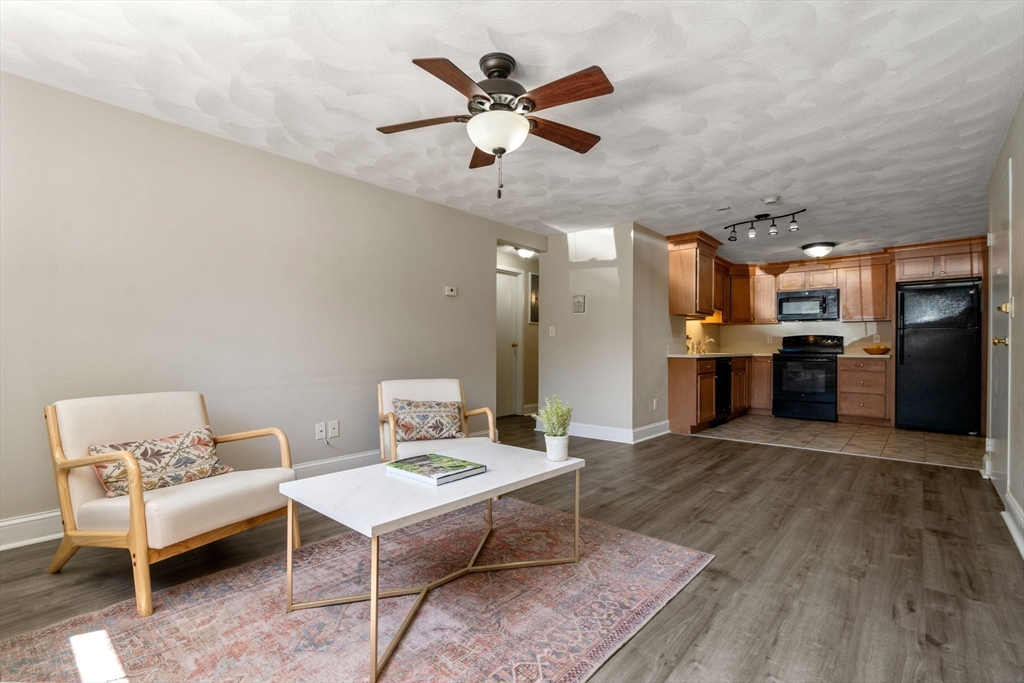 1105 Lexington Street, Unit 41 Waltham, MA 02452 - Photo 1 of 19 a living room with furniture and kitchen view