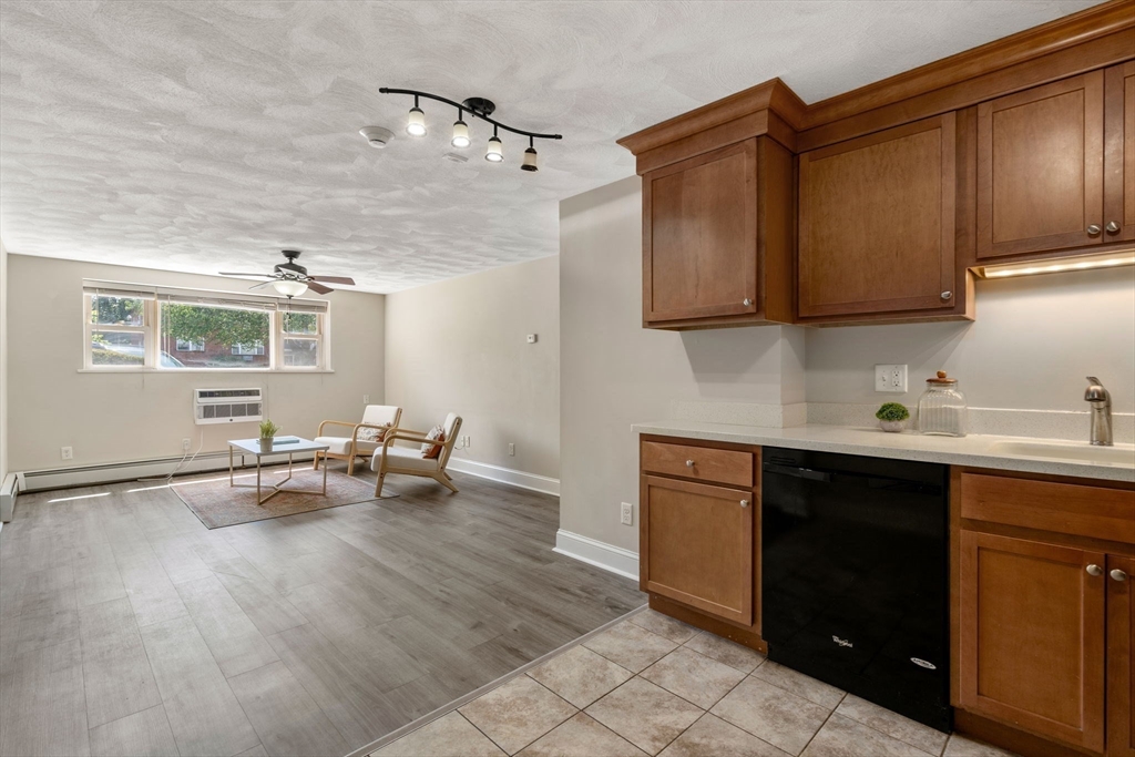 1105 Lexington Street, Unit 41 Waltham, MA 02452 - Photo 2 of 19 a kitchen with sink cabinets and stove top oven
