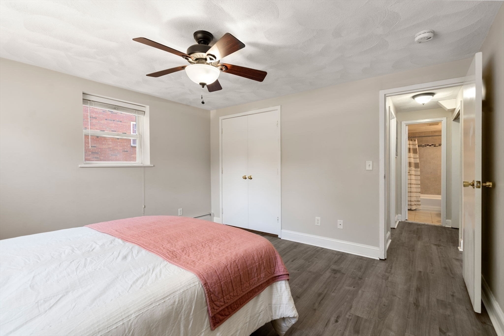 1105 Lexington Street, Unit 41 Waltham, MA 02452 - Photo 7 of 19 a bedroom with a bed and a ceiling fan